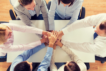 close up of business team with hands on top