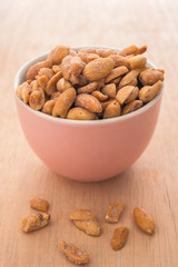 Peanut in a pink bowl and spilling out of a bowl