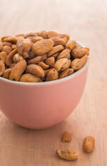 Peanut in a pink bowl and spilling out of a bowl