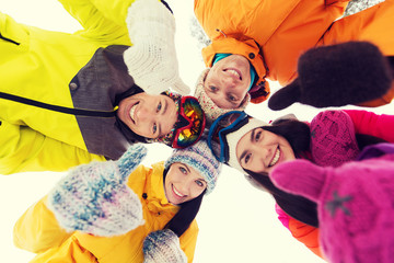 happy friends in winter clothes outdoors