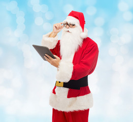 man in costume of santa claus with tablet pc