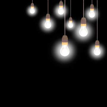 Illuminated. Old frosted glass light bulbs over black.