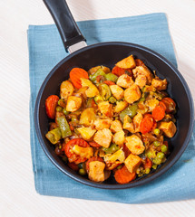 meat stew with mixed vegetables in a frying pan