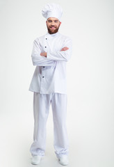 Smiling male chef cook standing with arms folded