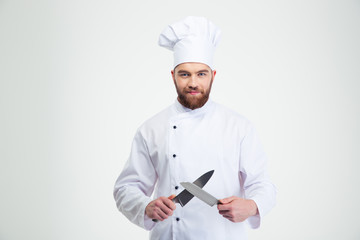 Happy male chef cook sharpening knife