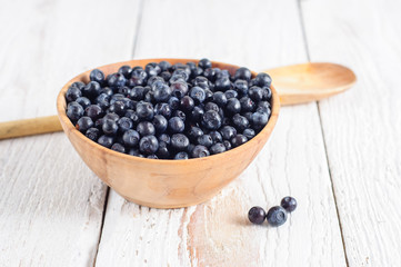 Wooden bowl with forest blueberry