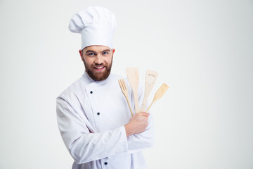Smiling man cook holding spoons