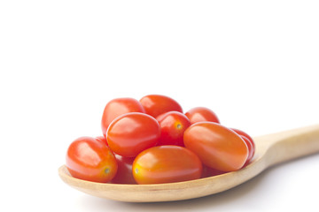 tomatoes on wooden ladle  isolated on white background