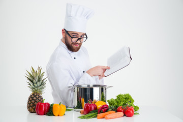 Male chef cook in glasses holding receipe book