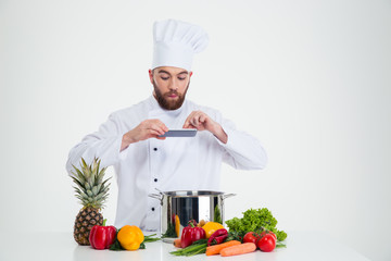 Male chef cook making photo of food