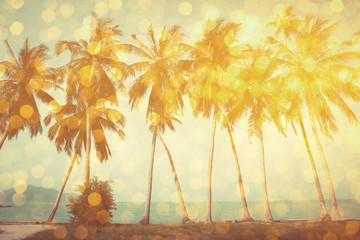 Palm trees on tropical beach with golden party glamour bokeh overlay, double exposure effect stylized
