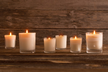 Fototapeta na wymiar scented candles on old wooden background