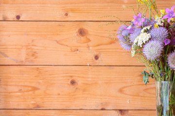 Purple flowers on a background of wooden boards