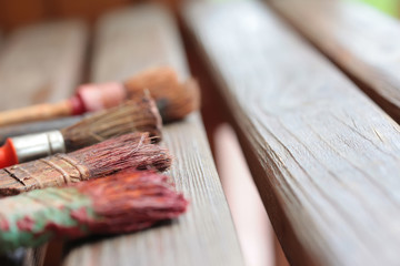 Old brushes on wooden boards