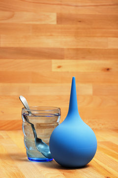 A glass of water and enema for the clean-out of stomach and treatment of constipation. Cleaning procedures for the body