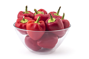 Fresh hot red bell peppers in glass bowl, isolated on white background