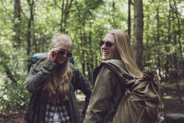 Twin sister having fun in forest.