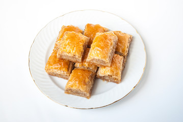 Sweet Baklava on plate isolated on white background.
