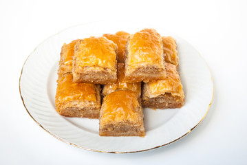 Sweet Baklava on plate isolated on white background.