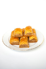Sweet Baklava on plate isolated on white background.