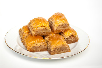 Sweet Baklava on plate isolated on white background.