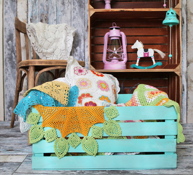 knitted home decorations in wooden box