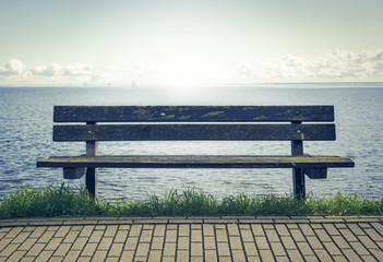 Wooden bench in front of the sea.