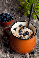 Bowl of oatmeal porridge with blueberry