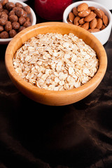 oat flakes, various ingredients for breakfast on black table