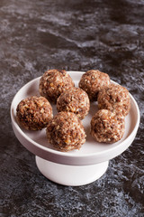Homemade healthy vegan chocolate candy with dates, coconut flake