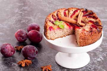 Homemade pie with plums on the table