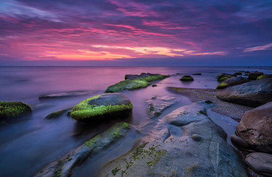 Fototapeta Sea rocks at sunrise. Magnificent sunrise view in the blue hour at the Black sea coast, Bulgaria 