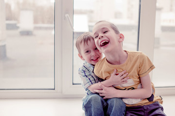 tickling. two cute laughing boy tickle each other