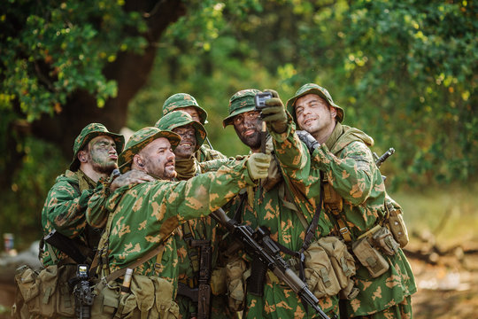 Selfie! soldiers taking pictures in the forest