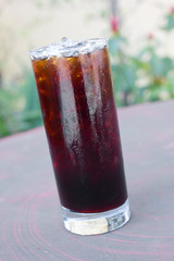 Iced Americano on wood table.