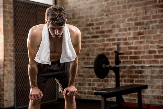 Muscular Man With Hands On Knees