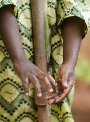 Young African school boy holding hands under a tap. Water scarcity problems concern the inadequate access to safe drinking water. 1 billion people in the developing world don't have access to it.