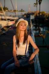 The beautiful girl on walk on the yacht club mooring