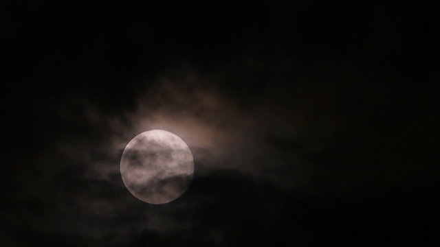 Fullmoon on dark sky that full with cloud,on28th Sep15, seen from Bangkok,Thailand