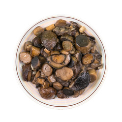 Roasted wild mushrooms on a plate isolated on white