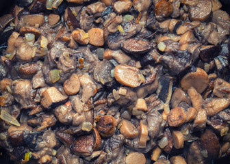 Closeup view of roasted wild mushrooms and onion