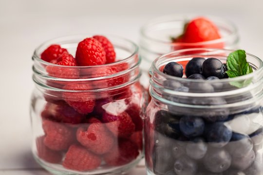 Glass jars of fresh berries
