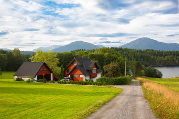 flaunts red house on the shore of the Norwegian Sea with views of the mountains and the forest but