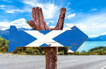 Scotland flag wooden sign with road background