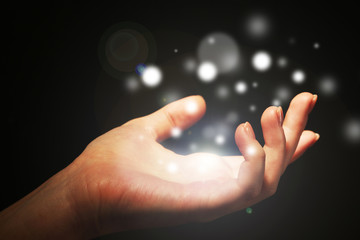Light in human hand in the dark,  miracle concept