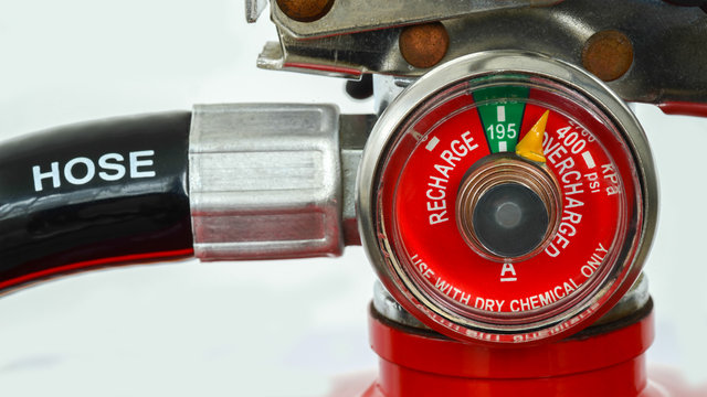 Detail of fire extinguisher pressure gauge indicator showing level of chemical liquid inside