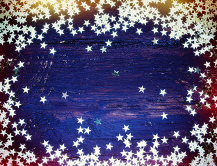 Glitter golden stars on grunge wood background. Holiday Backgrou
