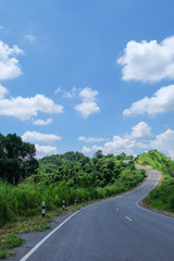 Road, hill and blue sky - Stock image
