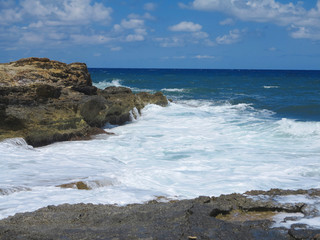 Big waves on rock coast blue sea and sky on Crete