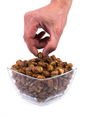 Hand taking a broad bean from transparent bowl isolated on white background